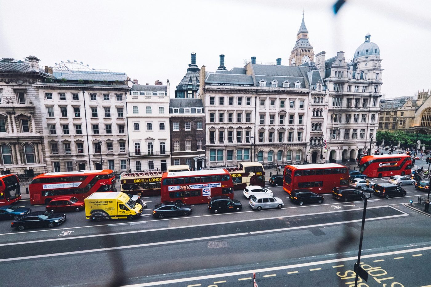 London buses and cars moving through a city area